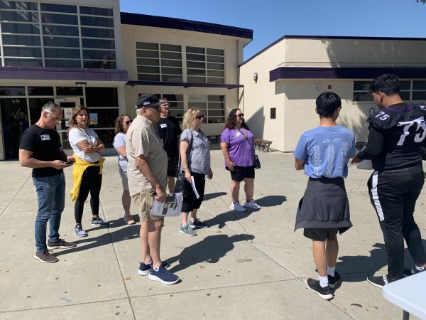 Two LINK Leaders engage in a lively discussion with visiting Amador alumni, sharing insights and anecdotes about the intimate charm of the small gym during the campus tour.