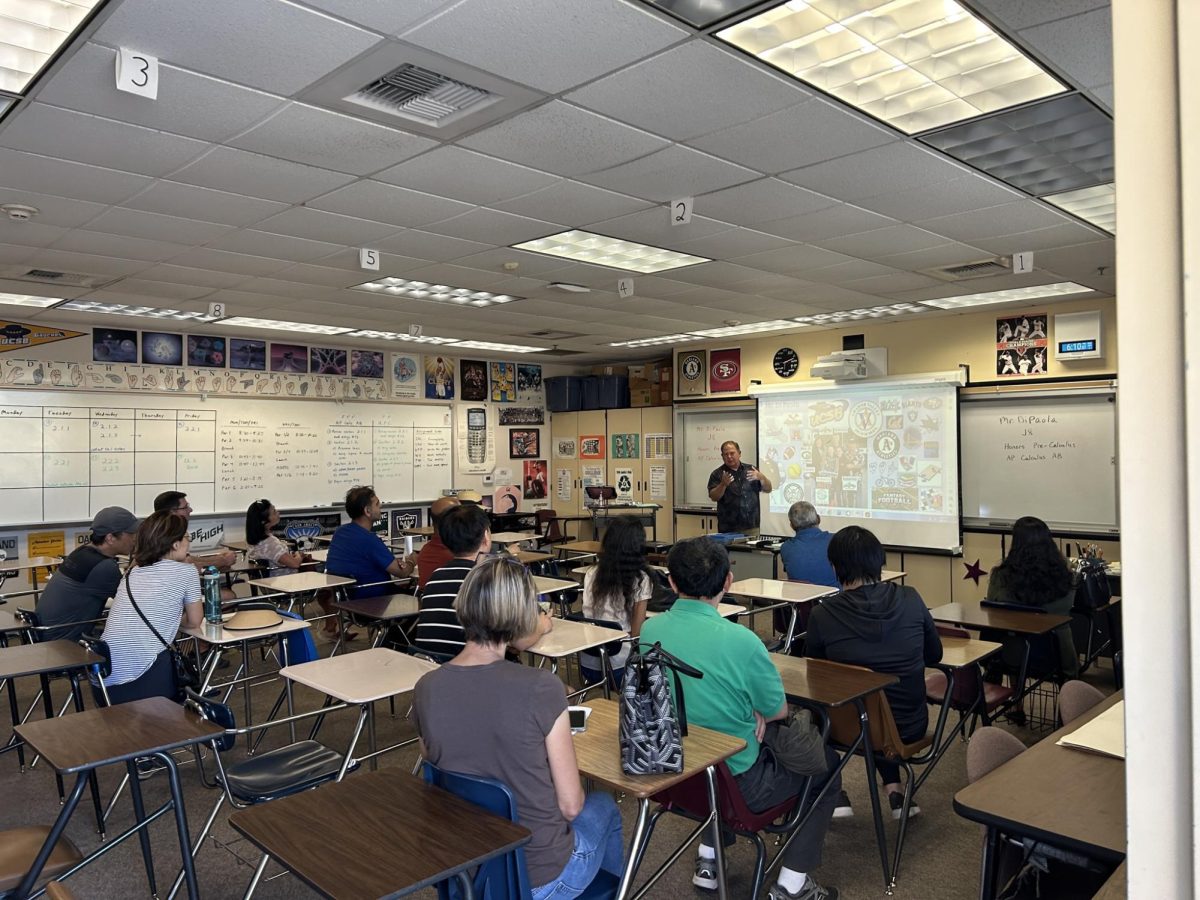 Like most teachers, math teacher Michael Di Paola goes over his class syllabus with his students’ parents.