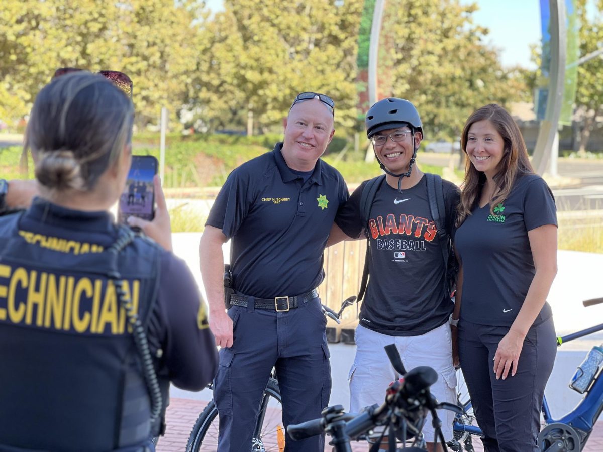 Dublin Police Chief Nate Schmidt and Dublin Mayor Melisa Hernandez share a rewarding photo opportunity with a participant at the conclusion of the bike ride.