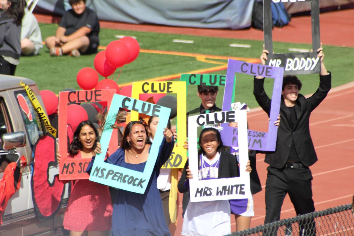 Sophomores walk with their float during the rally, showing off their Clue-themed outfits.