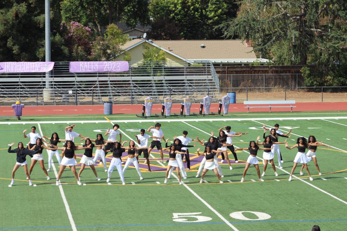 Bollywood dances in their black and white gear in front of the school community. 