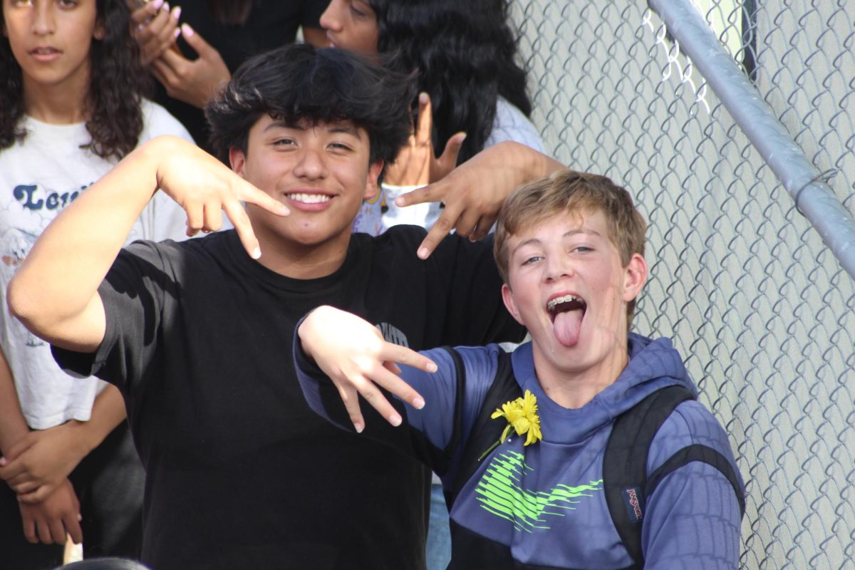 Students at the rally smile for the camera. 