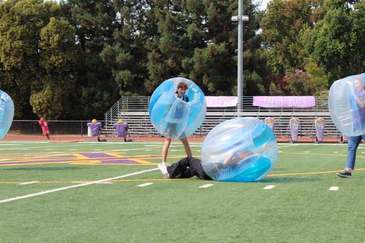 Students and teachers engage in a bubble knockout. 