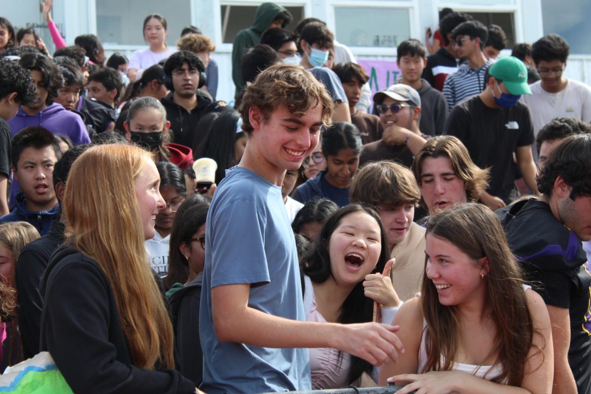 Students in the crowd cheer one final time as the rally comes to a close.