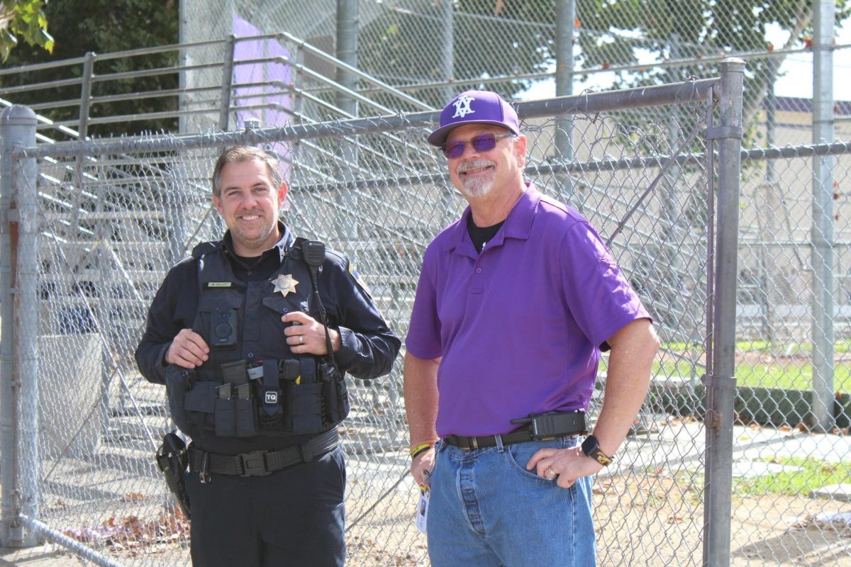 Principal Jon Fey and Officer Marty Billdt pose for a photo at the Homecoming Rally.