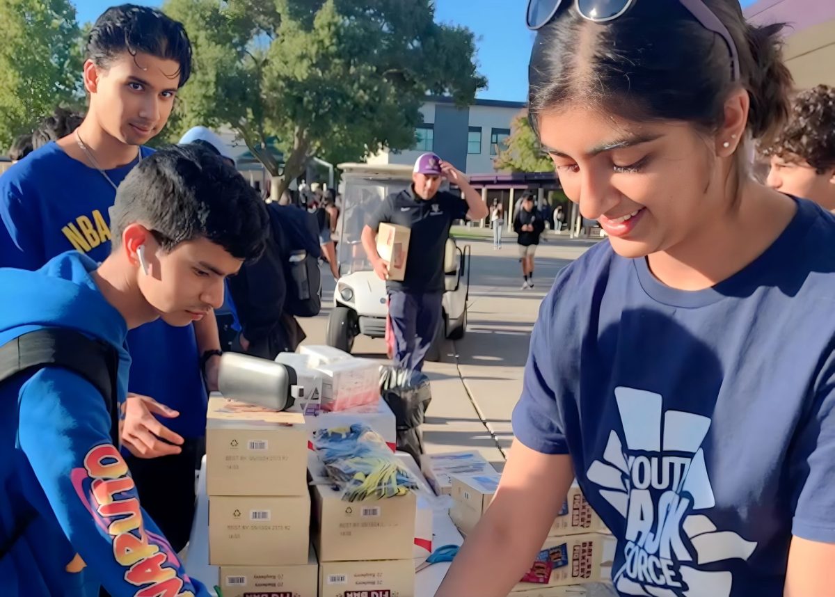 Gauri Chawla (24) gives out juice boxes and fig bars for the Walk and Roll event.