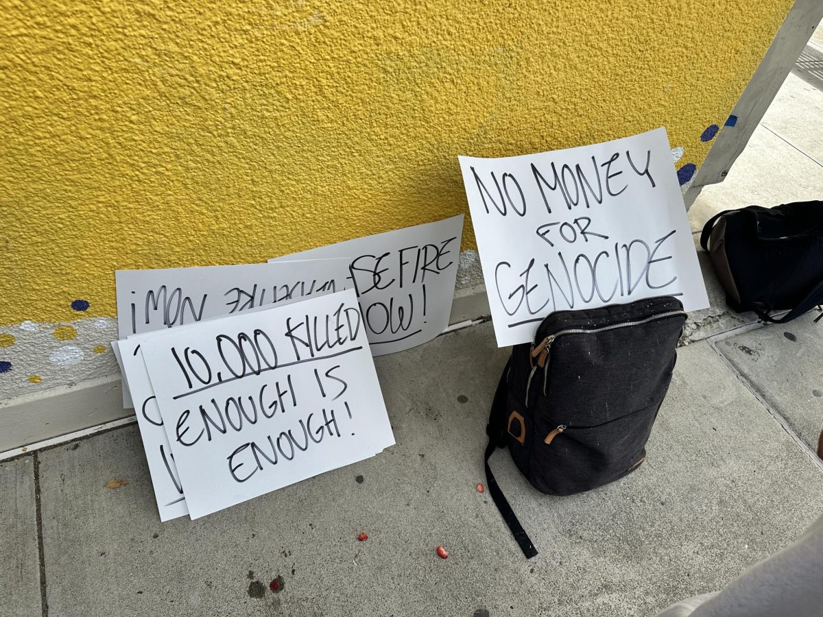 With less student-protesters than expected, some placed their signs on their bags and the B-Building wall.