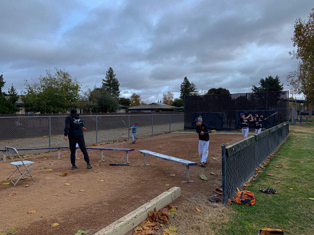 Hitting Coach Corey Forrester trains Little League players on batting techniques.