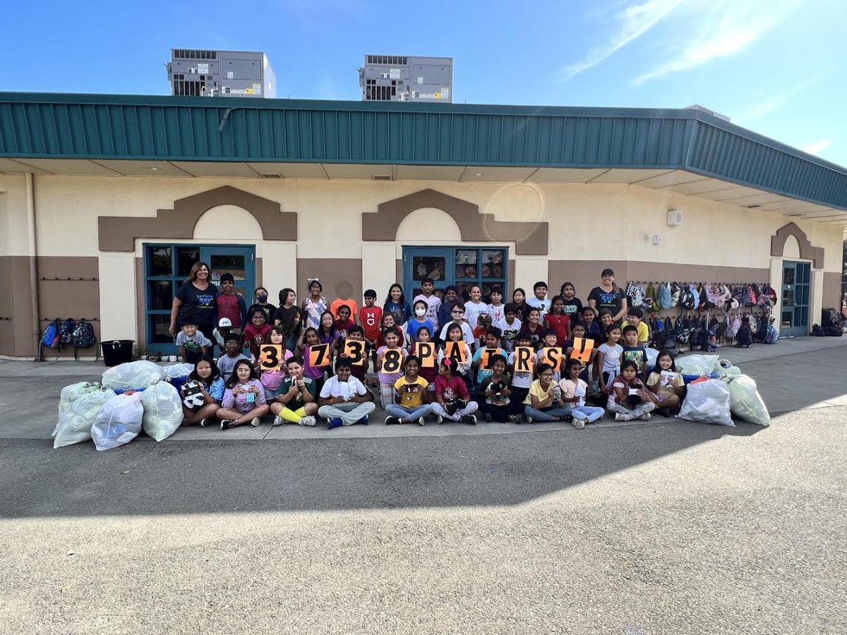 A class snaps a photo of with all of the donated socks.