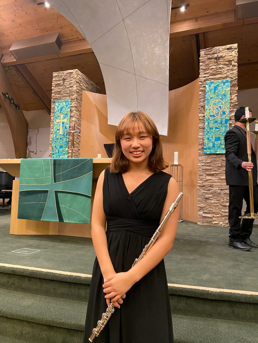 Emily Choe poses with her flute while performing at the band program’s benefit concert on January 25th. 