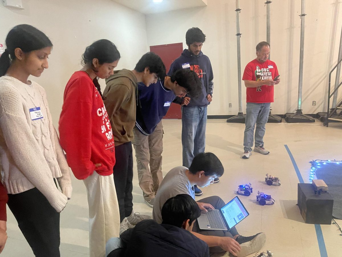 Students ran trials and checked the computers and robots before the audience entered.