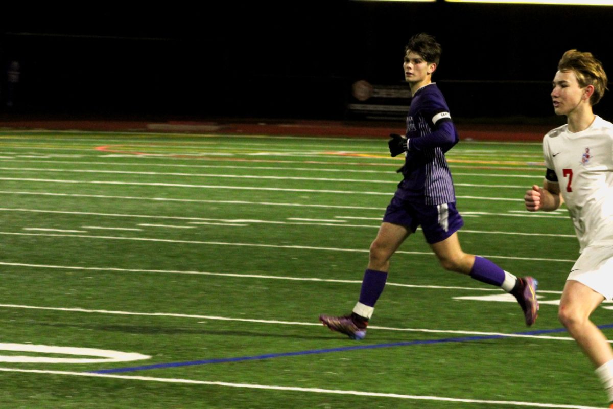 Max Couper ('24) hustles down the field, chasing a stray ball on Dublin's side. 