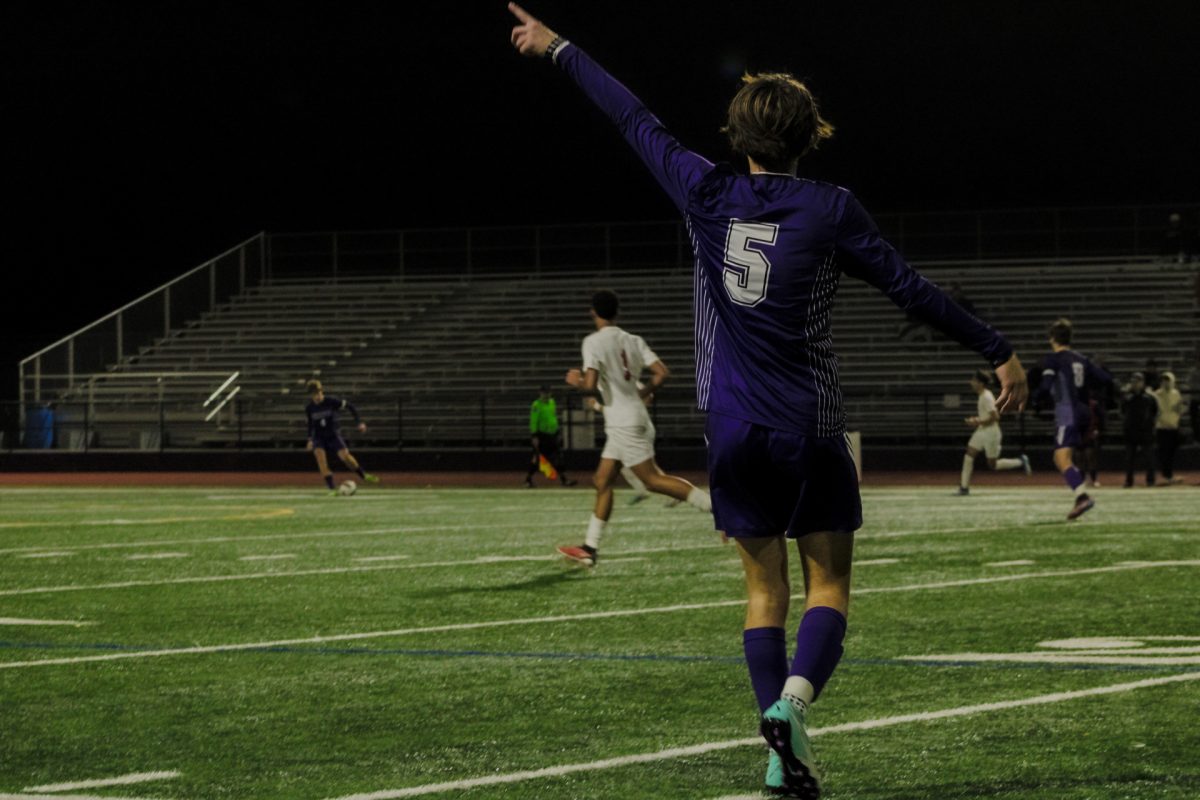 Full back Gus Shibloq (24) points out a possible pass for Isaac Hilton (24). 