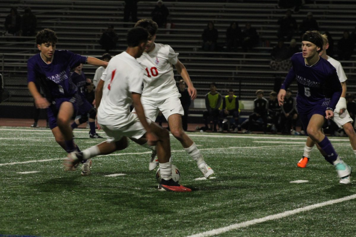 Nader Hannas ('25) and Gus Shibloq ('24) lock down Dublin players in a quick scuffle. 