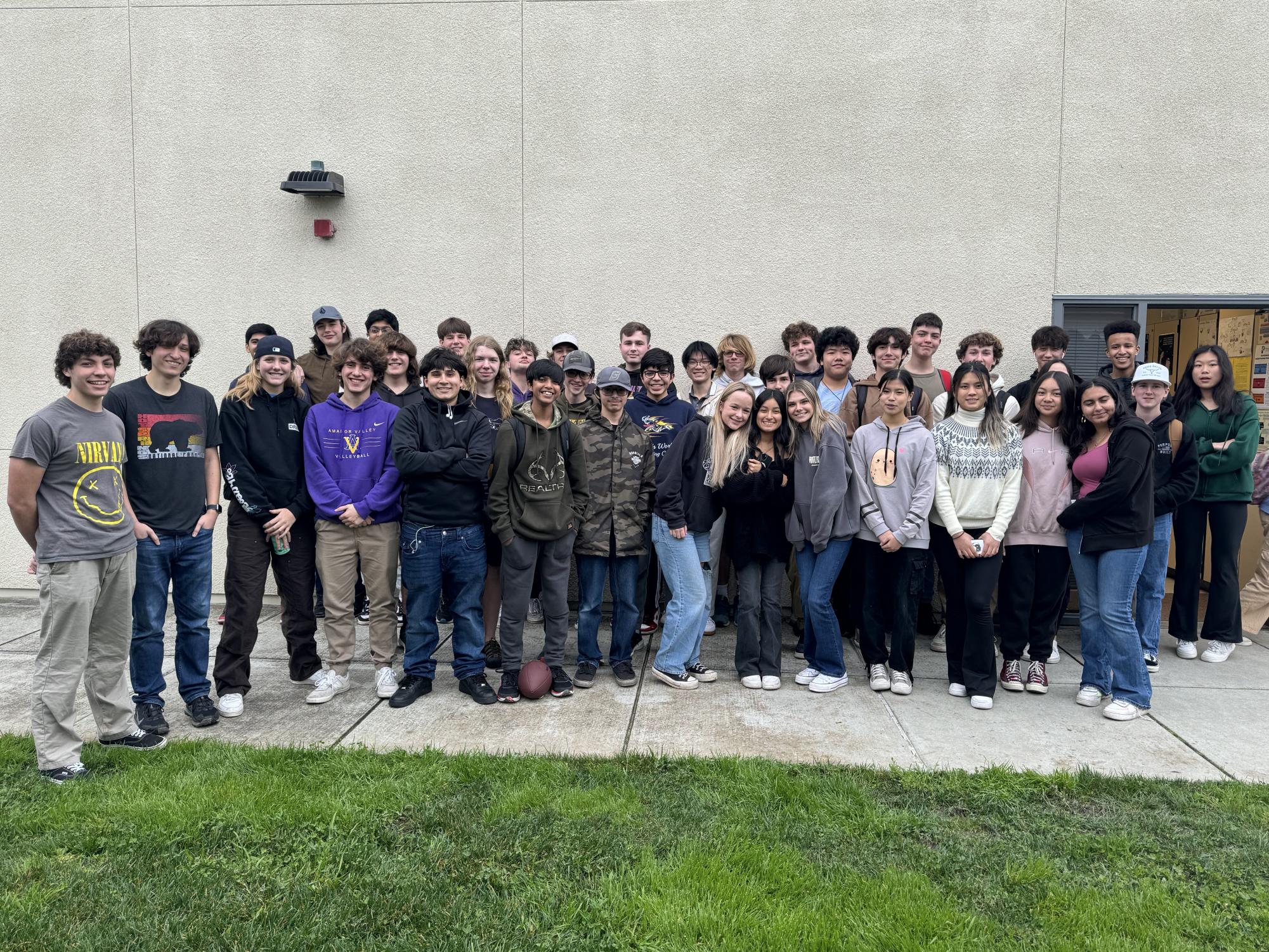Members of AV Fishing Club pile outside Mr. Lor's classroom for a group photo.
