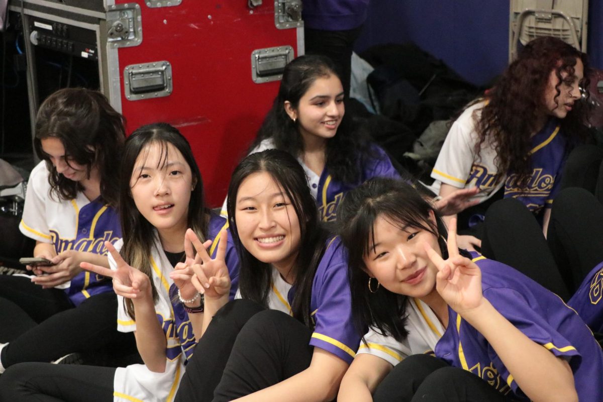 Peace out! Girls dance team poses for a pre-performance photo. 