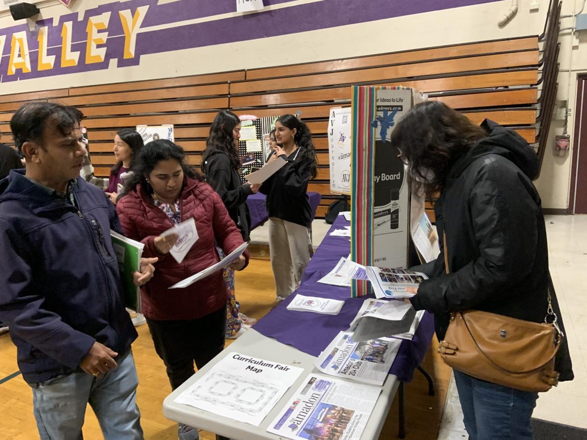 Parents check out the journalism tables.