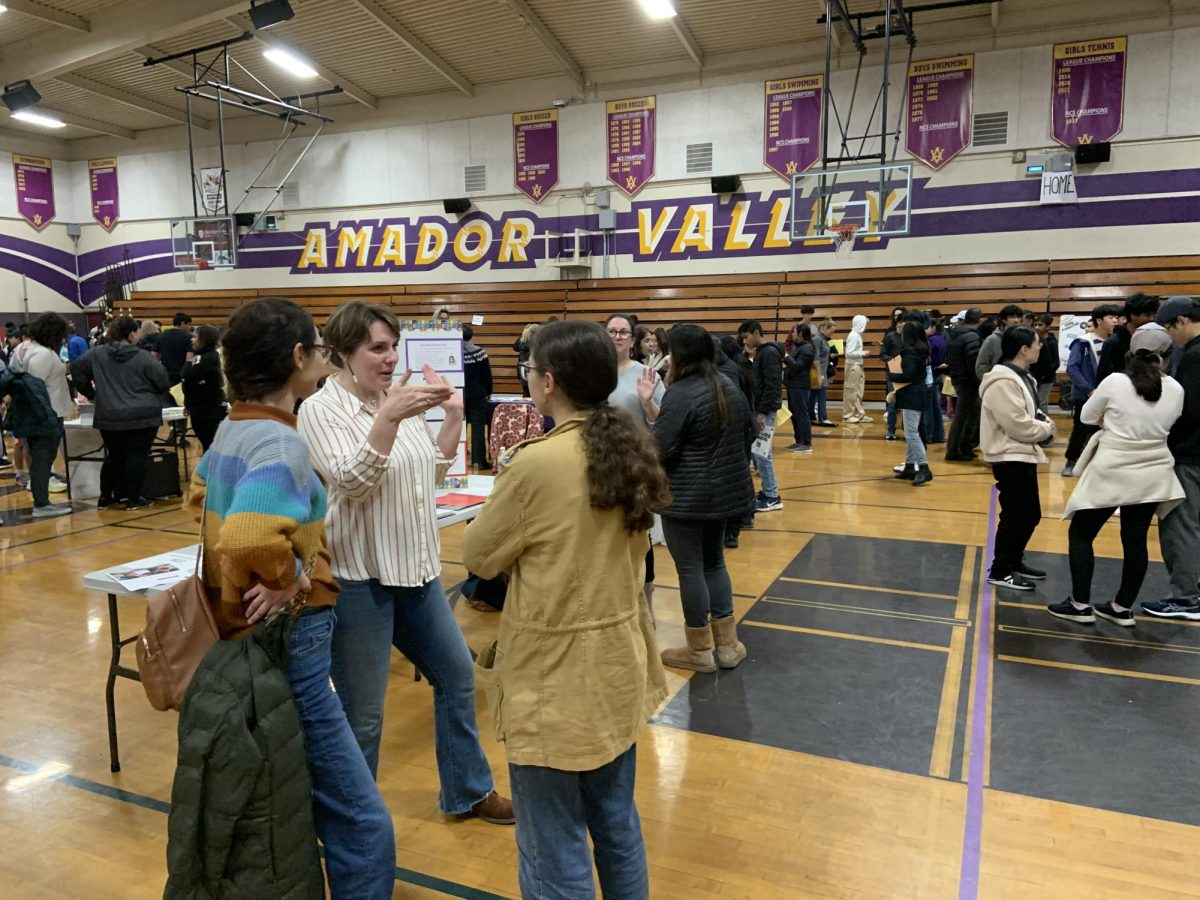A teacher speaks to interested parents.