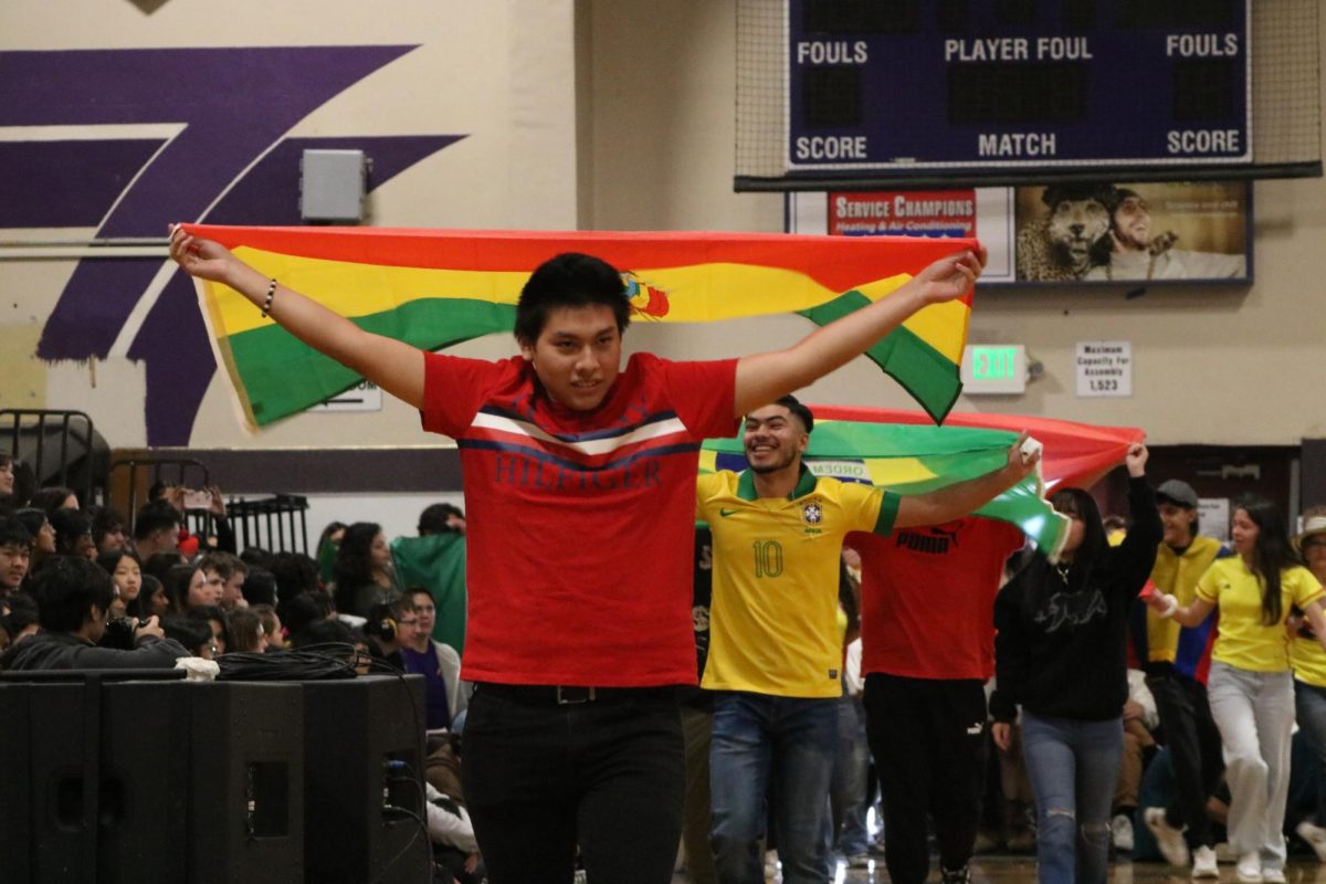 A Bolivian student shows his pride with the very vibrant flag of Bolivia. 