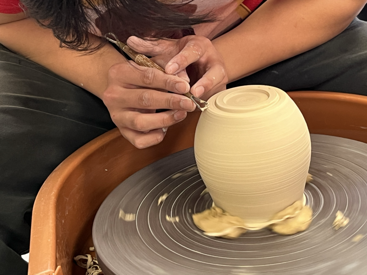 Thomas Le (24) uses a potters wheel