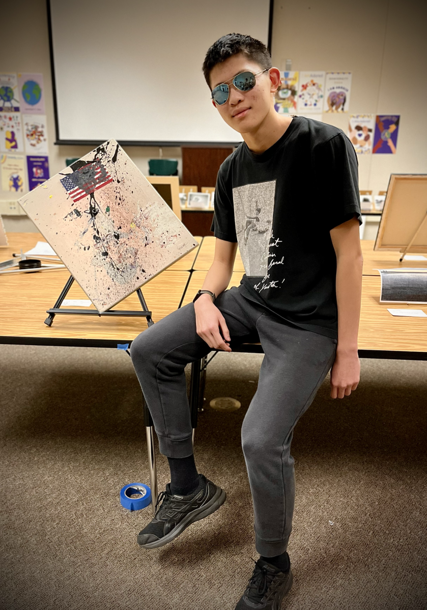 Erick Liu (26) poses with his artwork