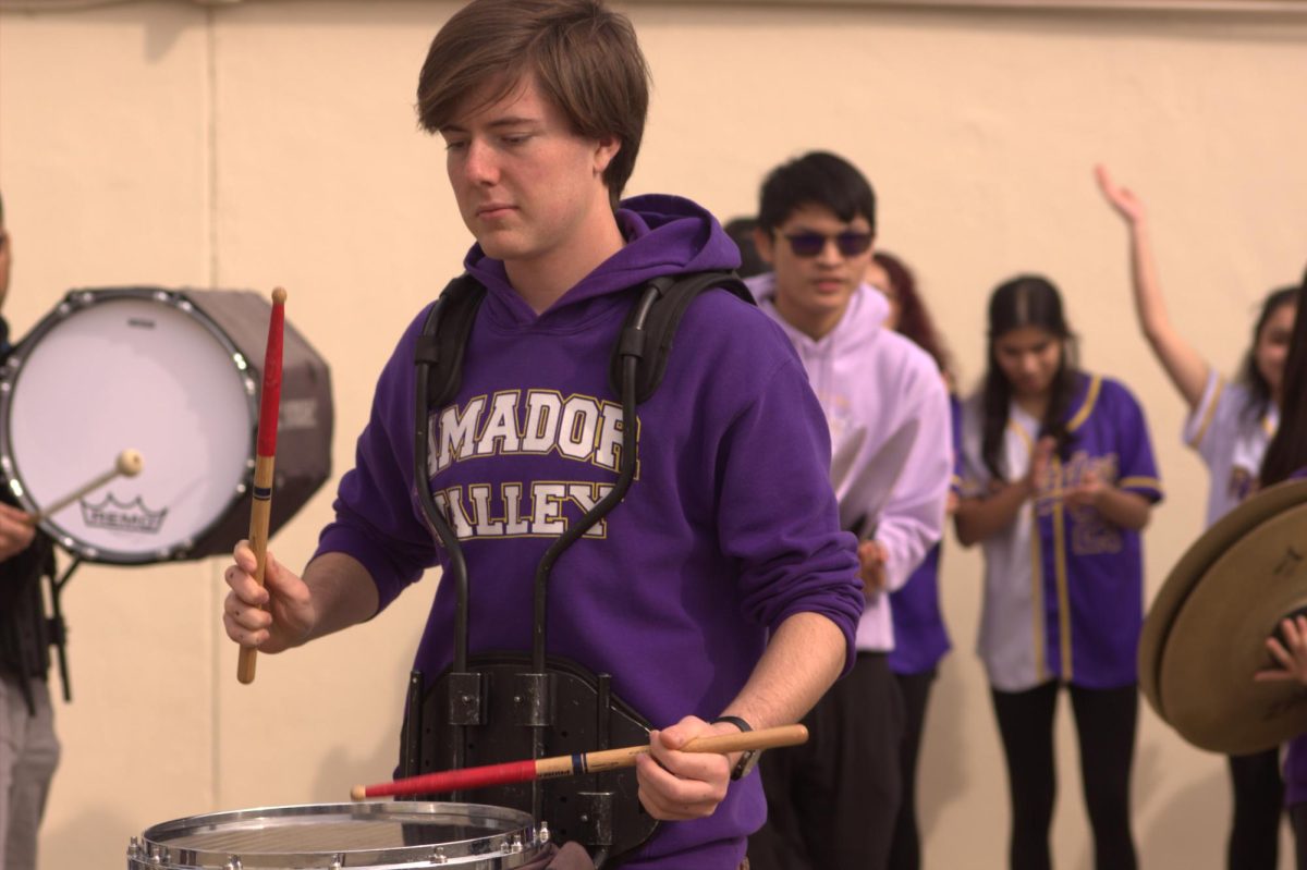 James Borris (24) leads his fellow band students in the different exercises to get the school excited for the rally.