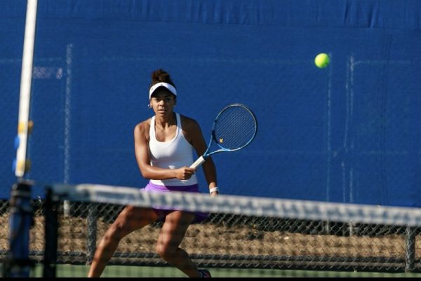 Montana Parkinson-Lubold returns a serve during a tennis match. 