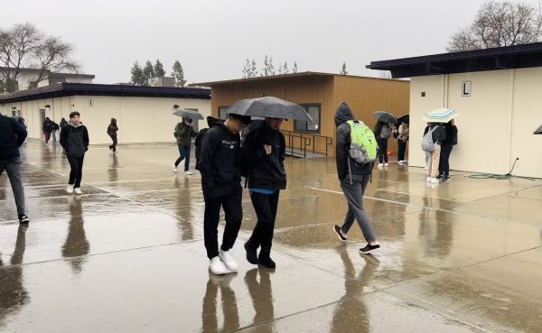 During school passing periods, students huddled under umbrellas to shield themselves from the relentless downpour.
