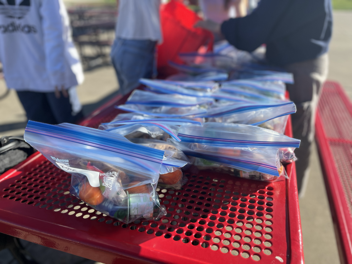 After school, club members gather to arrange care packages before a donation.