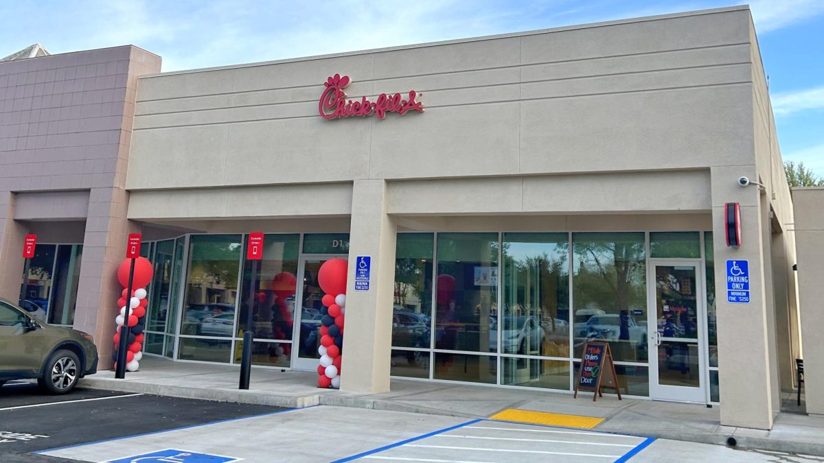 The exterior of the new Chick-fil-A store surrounded with balloons in the parking space. 