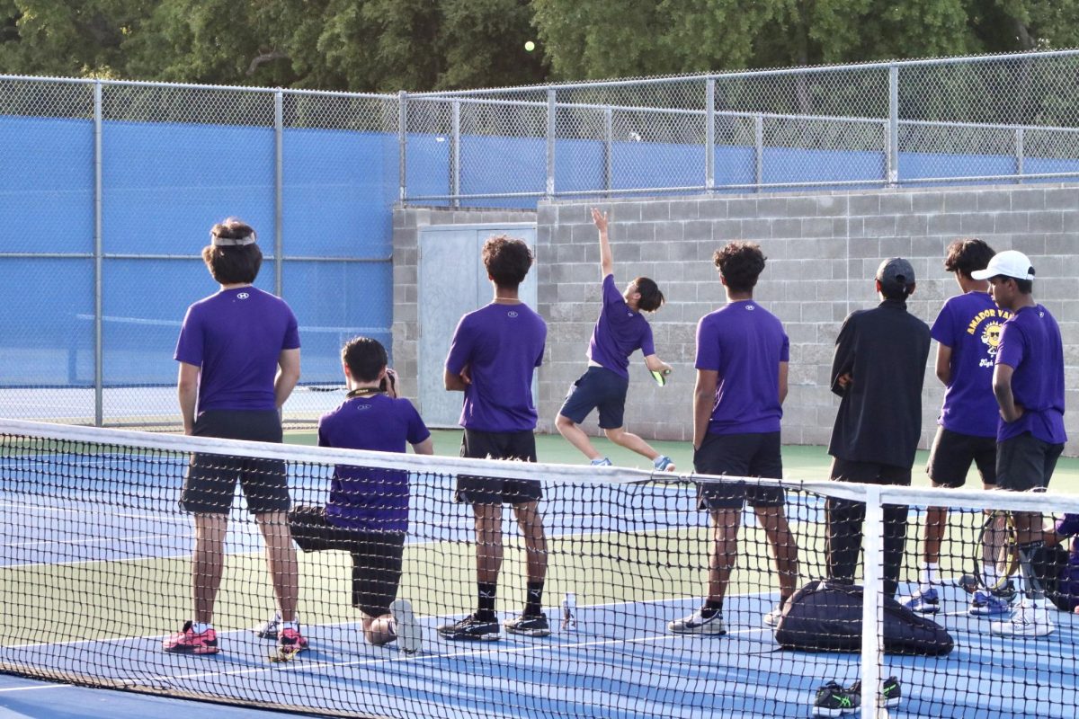 The Amador varsity boys tennis team intently watch Minsung Kim (25) serve during the tie-breaking game.