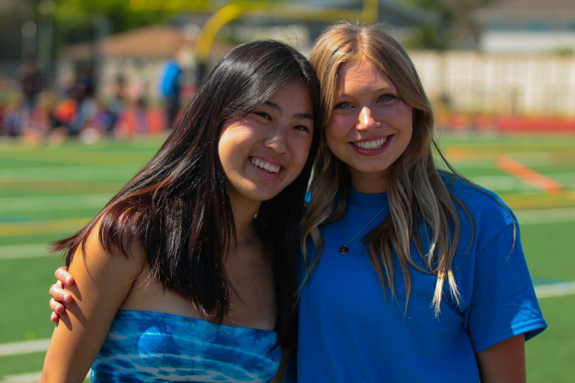 Kacie Hu (24) and Bella Vollgraf (24) rock their senior shade of blue. 