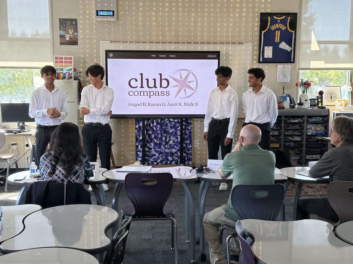 Seniors Karan Gupta, Nicholas Shao, Angad Bhargav, and Amit Krishna present their app, Club Compass, to the panel.