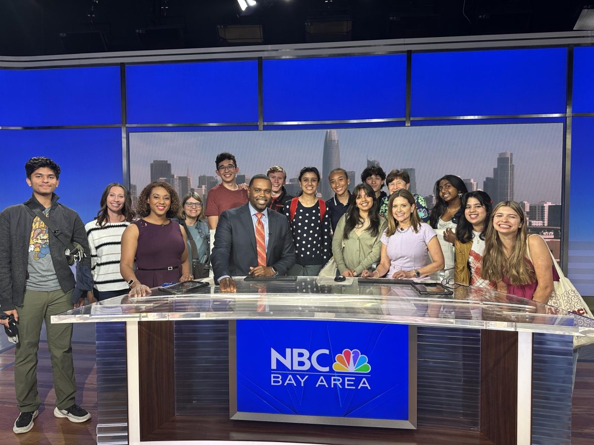 AV Journalism students pose with news anchors Marcus Washington and Laura Garcia, after watching a live taping of the midday newscast.