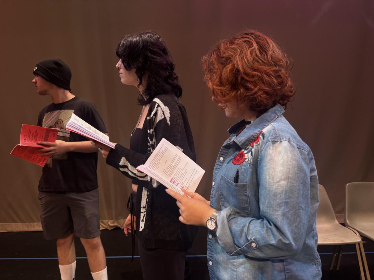 Ada Krechet ('26) diligently reviews her lines as she awaits rehearsals to begin.
