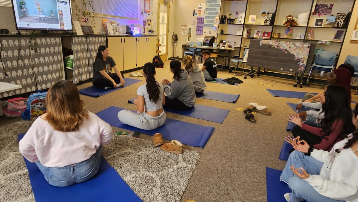 Support counselor, Ms. Yu, guides this group of students through meditative yoga as they decompress.