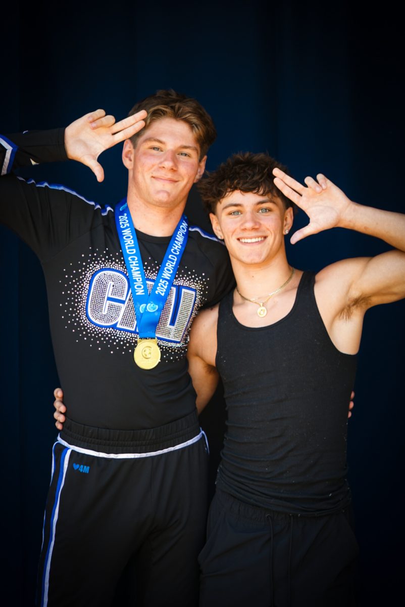 Adin Lively poses with his brother after winning the 2025 World Championships for Cheerleading