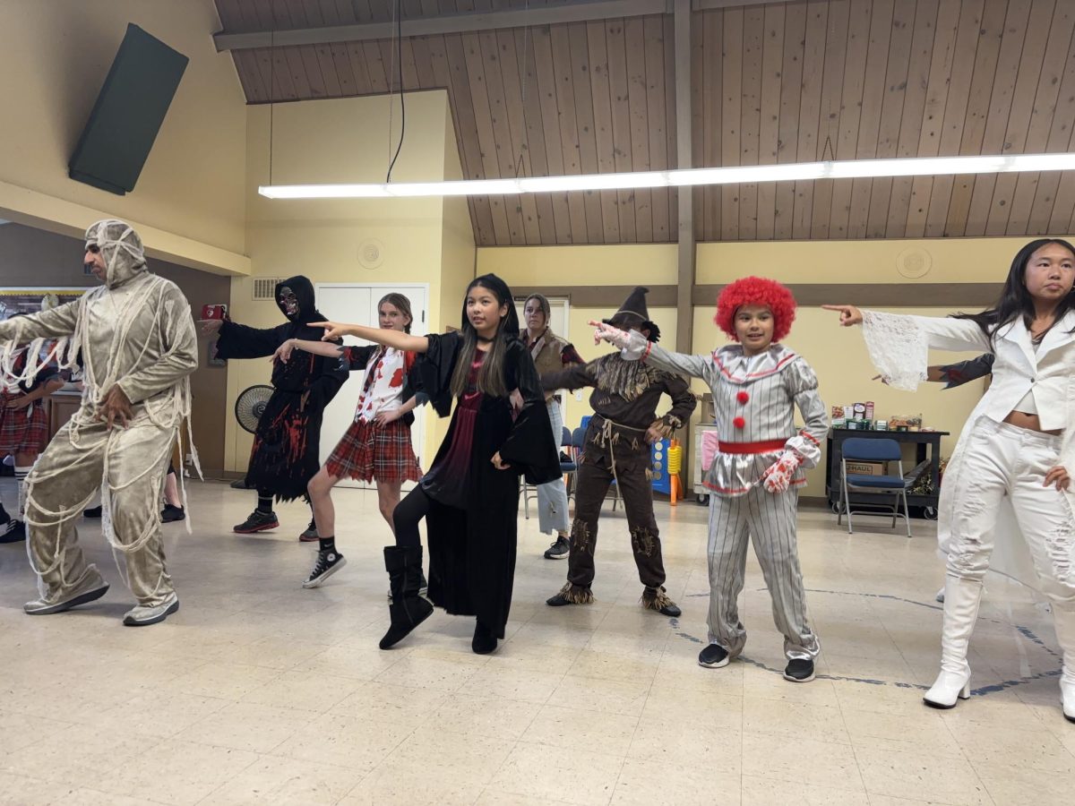 A cast of spooky characters line up in formation for one of Graveyard Grooves' musical numbers.
