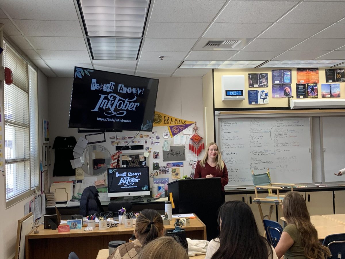 Amador Writers Ensemble president, Bella Burns (‘26), presents the details of the Inktober writing competition to club members.