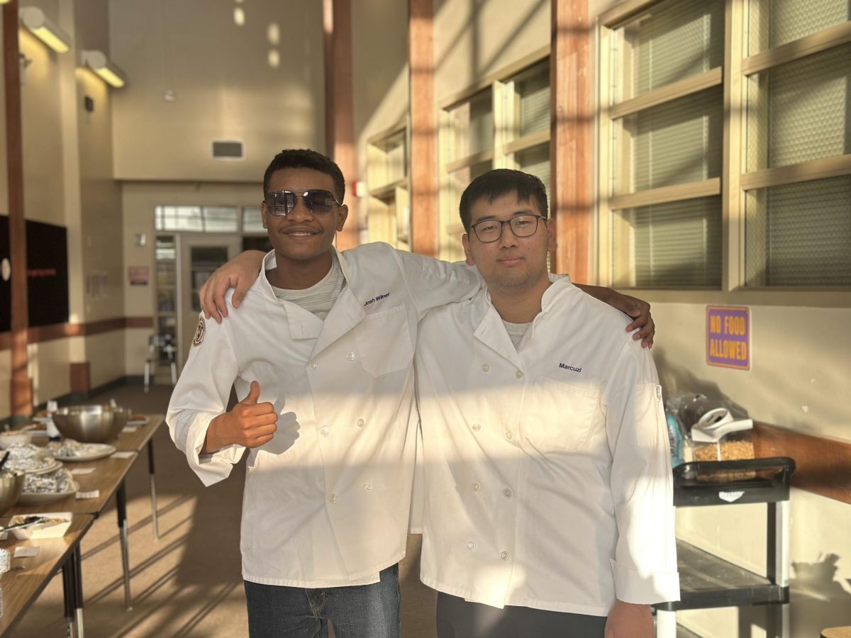 Shein Bnoit('27) and his Culinary classmate stand ready to serve staff at the Staff Meeting Breakfast on Friday, October 10 in the Amador library hallway.