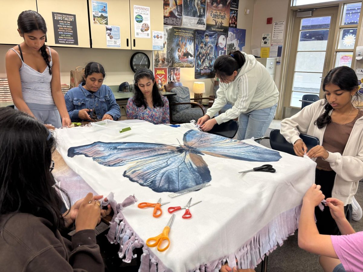 Scottie's Gift Foundation club members tie blankets with care, ready to be donated to patients in hospitals.