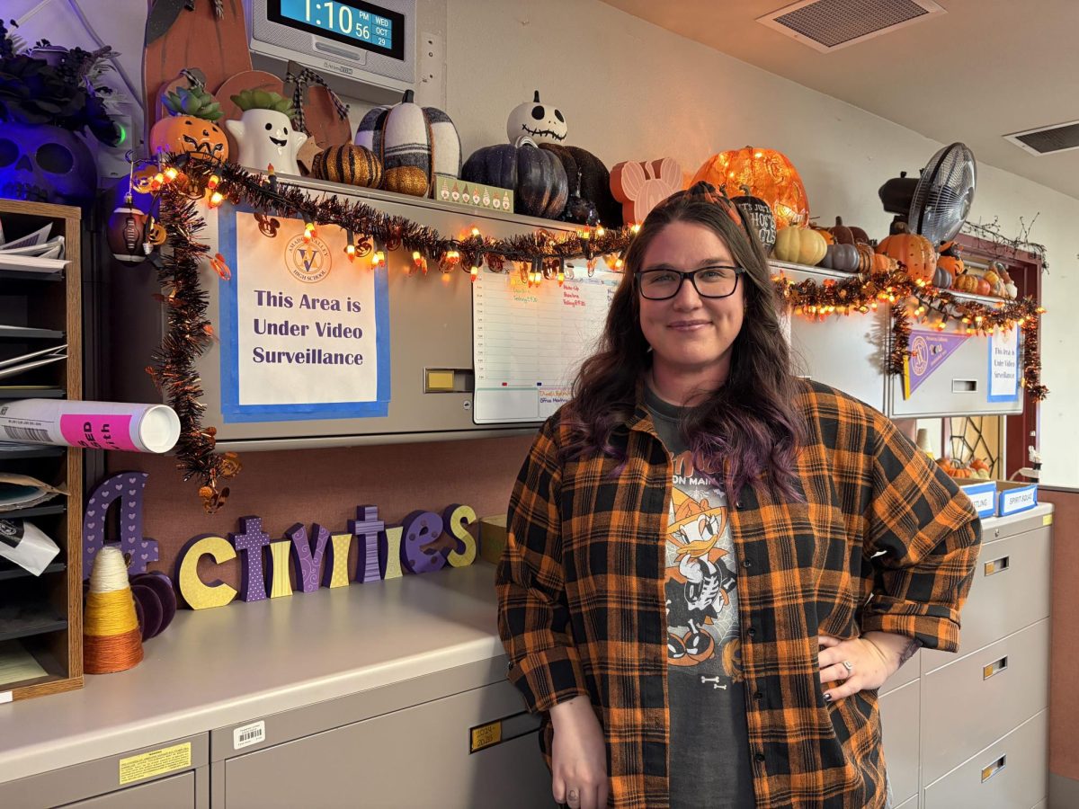 Meghan Andersson, ASB bookkeeper and school secretary, stands in front of the main activity center area. 