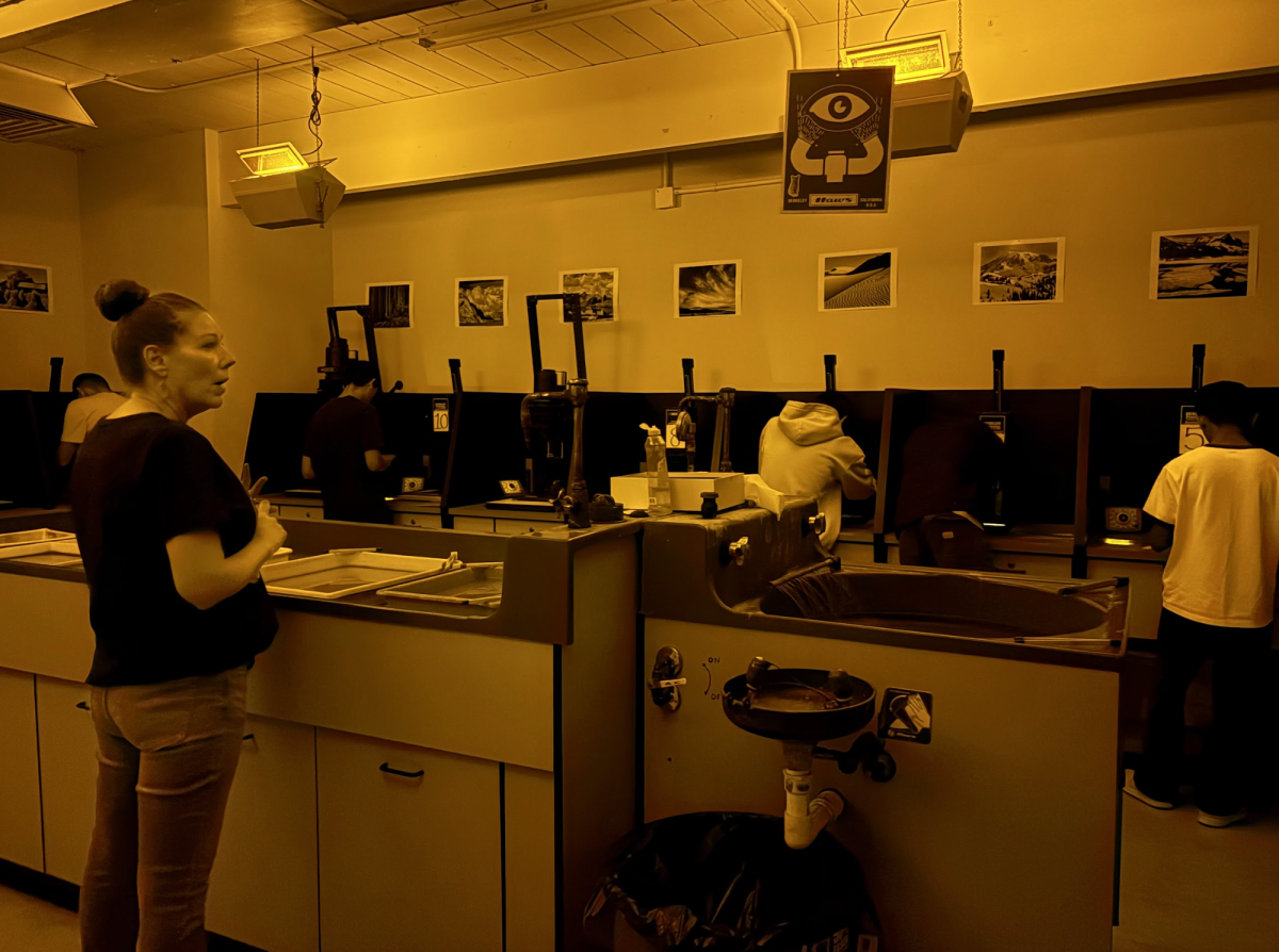 Photography teacher Merilee Fisher leads the class through photo development.
