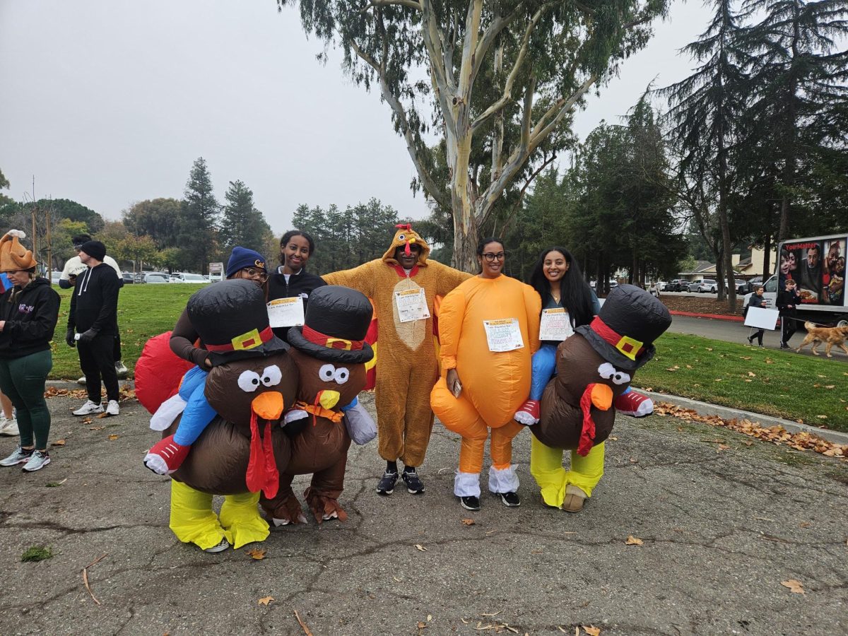 A family celebrates the Thanksgiving spirit in Turkey costumes at the annual Turkey Burn that took place in Ken Mercer Sport's Park.
