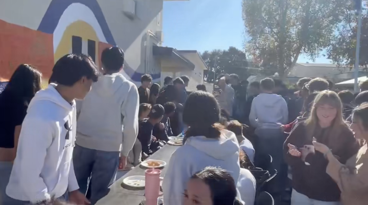 Cheers erupt as students attempt to finish their pie, without using their hands, in record time. 