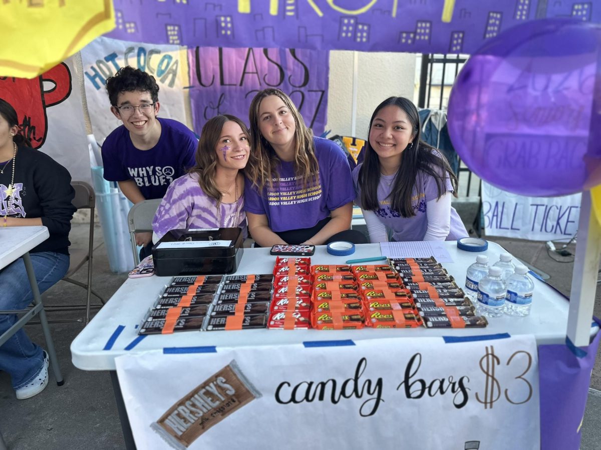 Vinh Esptein ('27), Avery Shea ('27), Addison Drain ('27), and Courtney Widiarto ('27) sell candy bars at the Class of 2027 booth. All proceeds go to Junior Prom.