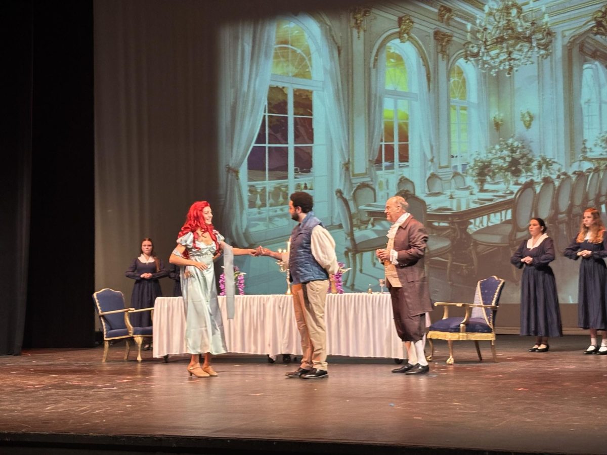Cast members Alaina Lewis and Caedon Perriman potray the roles of Ariel and Prince Eric in a tech rehearsal.