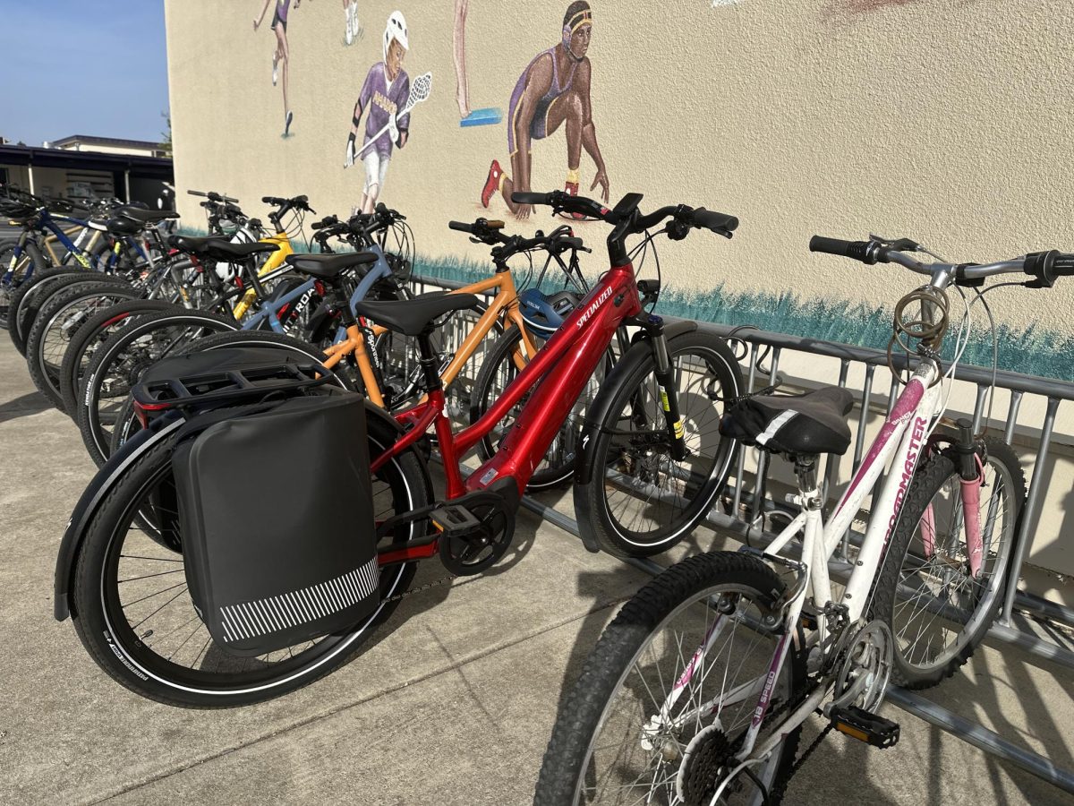 Several e-bikes line the Amador bike racks. On the surface, e-bikes appear almost the same as regular bikes, masking their electric power and the potential risks they carry.
