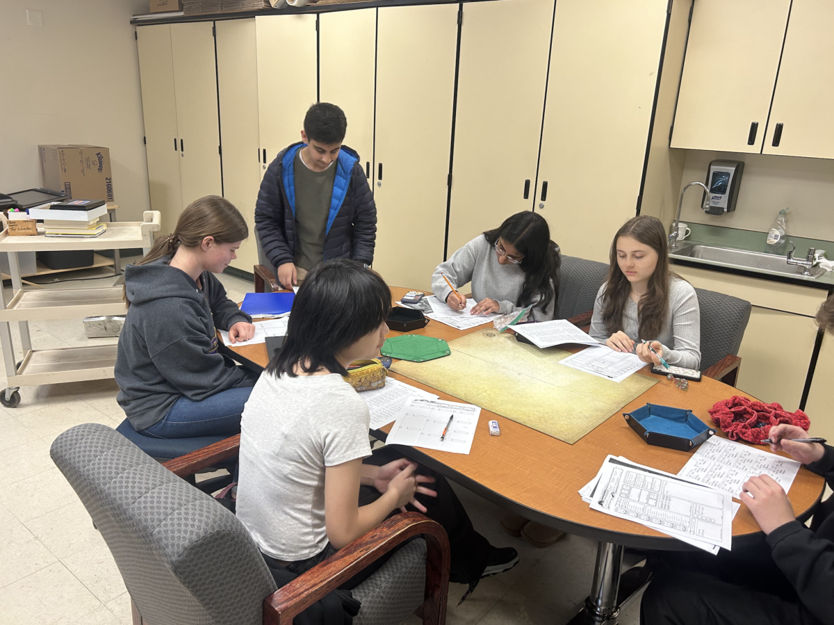 Students meet in the library to participate in the club