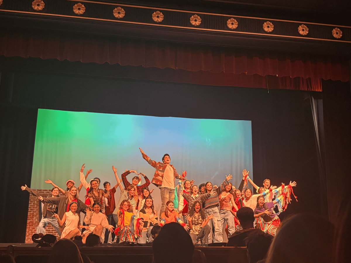 Trent Oliver, poses at the end of his song "Love Thy Neighbor" preaching acceptance to the students of Edgewater, Indiana.